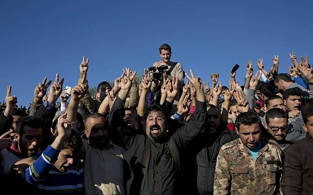 Mourners chant anti-US slogans during the funeral of Jordanian police Cpt. Anwar Abu Zaid, 28, at the cemetery of his home village of Rimoun, near the city of Jerash, Jordan, Thursday, Nov. 12, 2015. The police captain opened fire Monday on instructors at an international police training center in Jordan's capital, killing at least five people, including two Americans, before being shot dead by security forces. (AP/Nasser Nasser)