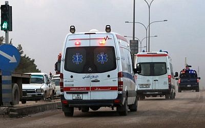 Ambulances leave the King Abdullah bin Al Hussein Training Center where a Jordanian policeman went on a shooting spree in Mwaqar on the outskirts of Amman, Jordan, Monday, Nov. 9, 2015. The policeman opened fire Monday on foreign trainers at a police compound, killing two Americans, a South African and a Jordanian and wounding two Americans and three Jordanians, according to government spokesman Mohammed Momani. (AP Photo/Raad Adayleh)