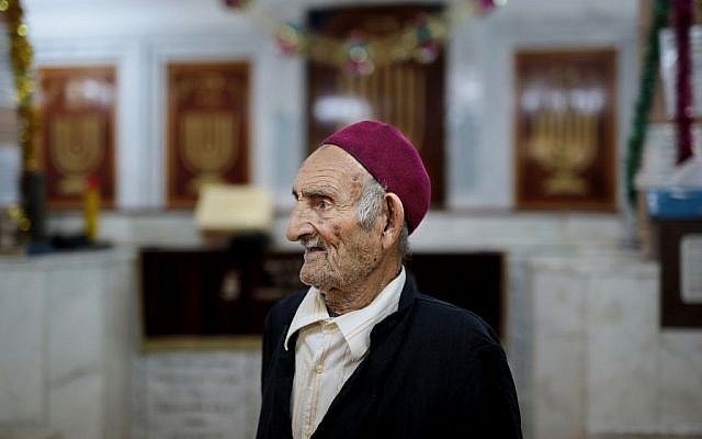 A caretaker of the Synagogue of the Kohanim of Djirt, pauses before prayers, at Hara Kbira, the main Jewish neighborhood on the Island of Djerba, southern Tunisia, October 29, 2015. (Photo by AP Photo/Mosa'ab Elshamy)