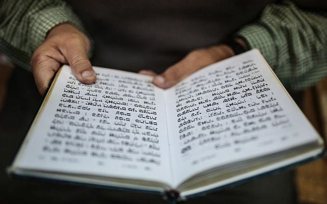 A Jewish man reads the Torah at La Ghriba, the oldest synagogue in Africa, on the Island of Djerba, southern Tunisia, October 29, 2015.