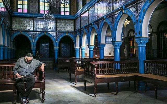 A Jewish man rests in La Ghriba, the oldest synagogue in Africa, on the Island of Djerba, southern Tunisia, October 29, 2015.