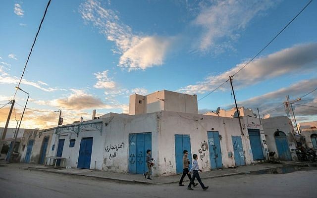 Boys walk past closed shops on the beginning of Shabbath, after sunset, at Hara Kbira, the main Jewish neighborhood in the Island of Djerba, southern Tunisia, October 29, 2015. (Photo by AP Photo/Mosa'ab Elshamy)