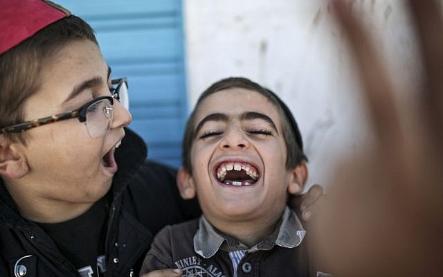 Boys play outside their school at Hara Kbira, the main Jewish neighborhood on the Island of Djerba, southern Tunisia, October 29, 2015. (Photo by AP Photo/Mosa'ab Elshamy)
