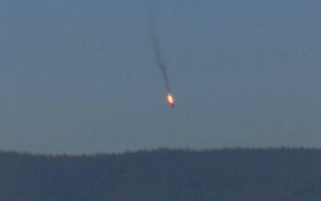 A Russian warplane on fire before crashing on a hill as seen from Hatay province, Tuesday, November 24, 2015. (screen capture: Haberturk TV via AP)