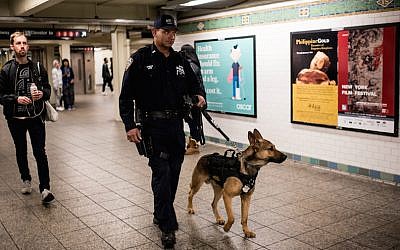A police officer patrolling the Times Square subway stop in New York City the day after a series of terrorist attacks in Paris, on November 14, 2015. (Andrew Renneisen/Getty Images via JTA)