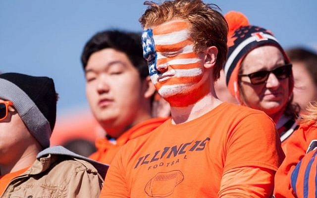 An Illinois fan pauses before an NCAA football game between Ohio State and Illinois in honor of those killed or injured in the Paris attacks., Saturday, Nov. 14, 2015 at Memorial Stadium in Champaign, Ill. (AP Photo/Bradley Leeb)