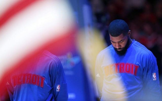Detroit Pistons' Marcus Morris looks down during a moment of silence for the victims of yesterday's terrorist attacks in Paris, France, before the start of an NBA basketball game against the Los Angeles Clippers in Los Angeles, Saturday, Nov.14, 2015. The Clippers won 101-96. (AP Photo/Christine Cotter)