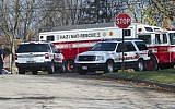 Fire and rescue workers of the City of Akron, Ohio, continue the recovery process at the site of Tuesday's jet plane crash in Akron, Wednesday, November 11, 2015. (AP/Phil Long)