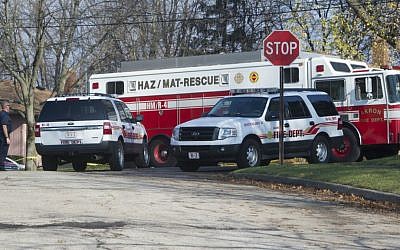 Fire and rescue workers of the City of Akron, Ohio, continue the recovery process at the site of Tuesday's jet plane crash in Akron, Wednesday, November 11, 2015. (AP/Phil Long)