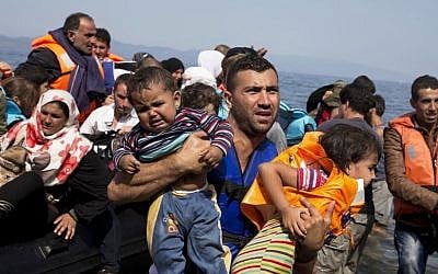 Syrian refugees arrive aboard a dinghy after crossing from Turkey to the island of Lesbos, Greece, on September 10, 2015. (AP/Petros Giannakouris, File)