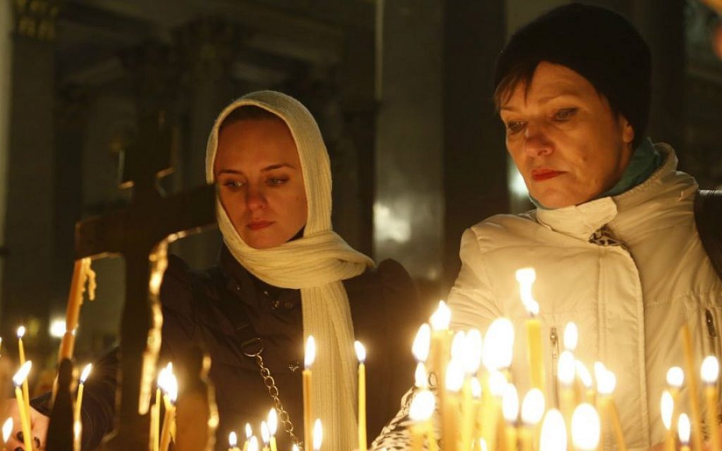 People light candles inside an Orthodox church in St. Petersburg during a day of national mourning for the plane crash victims, Russia, on Sunday, Nov. 1, 2015  (AP/Dmitry Lovetsky)