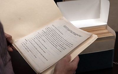 In this Wednesday, Nov. 11, 2015, photo, library archivist Tom White shows a folder containing some of the original transcripts from the Nuremburg trials in the archives at Duquesne University in Pittsburgh. (AP Photo/Keith Srakocic)