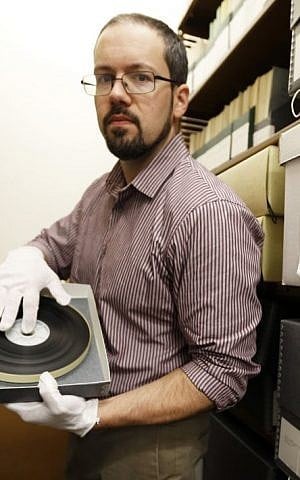 In this Wednesday, Nov. 11, 2015, photo, library archivist Tom White shows a reel of some of the original film made during the Nuremburg trials made by former Pennsylvania Supreme Court Justice Michael Musmanno at the archives in Duquesne University in Pittsburgh. (AP Photo/Keith Srakocic) 