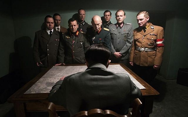 This photo provided by the Smithsonian Channel shows, an actor portraying Adolf Hitler, seated, addressing his top generals in the new Smithsonian Channel special, “The Day Hitler Died." (Smithsonian Channel via AP)