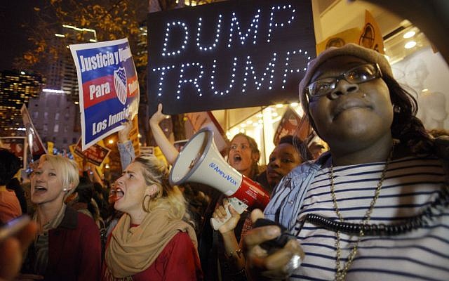 Sasha Murphy, of the ANSWER Coalition, leads demonstrators in a chant during a protest against Republican presidential candidate Donald Trump's hosting 'Saturday Night Live' in New York, November 7, 2015. (AP/Patrick Sison) Sasha Murphy, of the ANSWER Coalition, leads demonstrators in a chant during a protest against Republican presidential candidate Donald Trump's hosting 'Saturday Night Live' in New York, November 7, 2015. (AP/Patrick Sison)