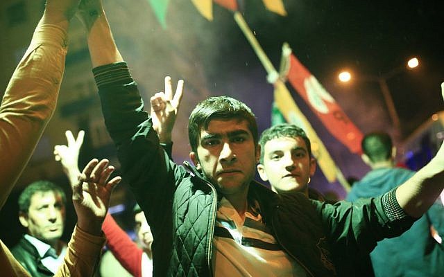 Youths use a flare as they celebrate preliminary election results of the pro-Kurdish Peoples's Democratic Party (HDP) in Diyarbakir, in Turkey's predominantly Kurdish southeast, late Sunday, Nov. 1, 2015 (AP Photo/Lefteris Pitarakis) Youths use a flare as they celebrate preliminary election results of the pro-Kurdish Peoples's Democratic Party (HDP) in Diyarbakir, in Turkey's predominantly Kurdish southeast, late Sunday, Nov. 1, 2015 (AP Photo/Lefteris Pitarakis)