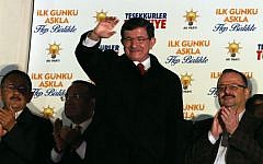 Turkish Prime Minister Ahmet Davutoglu salutes supporters gathered outside ruling Justice and Development Party headquarters in Ankara, Turkey, Sunday, Nov. 1, 2015. (AP/Burhan Ozbilici)