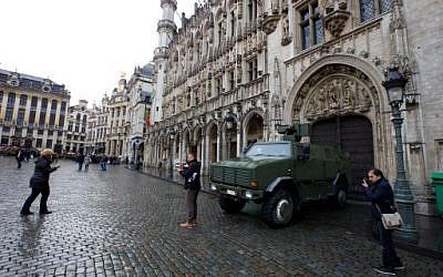 People posing for photos in front of a military vehicle next to the Grande Place square in central Brussels, November 21, 2015. (AFP/BELGA/Nicolas Maeterlinck) 