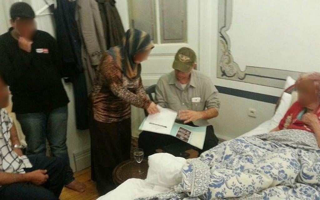 Israeli-American businessman Moti Kahana (center, in green ball cap), looks at documents with members of the Halabi family, the last Jews of Aleppo, whom he had transported out of Syria to Turkey. (courtesy Moti Kahana) Israeli-American businessman Moti Kahana (center, in green ball cap), looks at documents with members of the Halabi family, the last Jews of Aleppo, whom he had transported out of Syria to Turkey. (courtesy Moti Kahana)