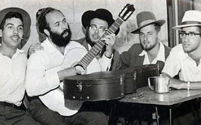 A young Rabbi Shlomo Carlebach playing guitar. (YouTube screenshot)