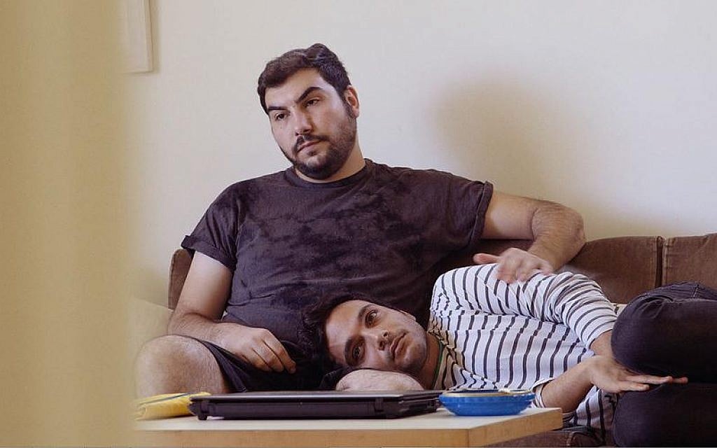 Palestinian Khader Abu-Seif (striped shirt) with his Jewish partner, David, in British director and producer Jake Witzenfeld's 'Oriented,' the story of three Palestinian gay men in Tel Aviv. (courtesy) Palestinian Khader Abu-Seif (striped shirt) with his Jewish partner, David, in British director and producer Jake Witzenfeld's 'Oriented,' the story of three Palestinian gay men in Tel Aviv. (courtesy)