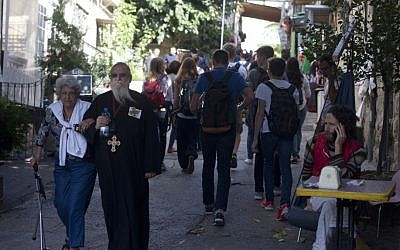 Tourists walk next to the Church of St. John the Baptist in Jerusalem's Ein Karem neighborhood on November 03, 2015 (Lior Mizrahi/Flash90)