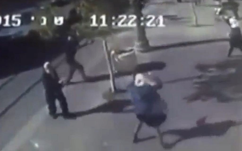 In a still image from security-camera footage of the scene, a young Palestinian girl (center) lashes out with a pair of scissors in an attack in Jerusalem on November 23, 2015. (screen capture: Channel 2)