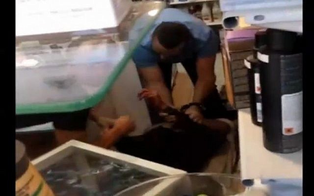 An image from the video footage showing an angry crowd of bystanders attempting to attack a Palestinian terrorist who stabbed 3 civilians on November 2, 2015. (screenshot: Channel 2) An image from the video footage showing an angry crowd of bystanders attempting to attack a Palestinian terrorist who stabbed 3 civilians on November 2, 2015. (screenshot: Channel 2)