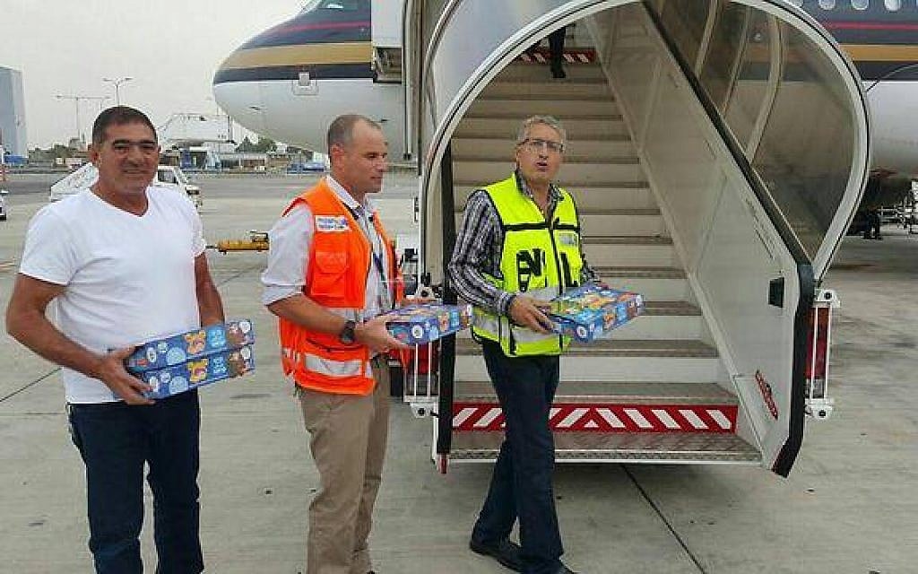 Ben Gurion Airport staff hold Israeli candies as they greet a Jordanian plane from Dubai that made an emergency landing in Tel Aviv on November 3, 2015 (photo credit: Israel Airports Authority)
