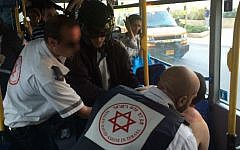 Magen David Adom medics treat an Israeli man, later identified as Daniel Cohen, 31, from Bnei Brak, on a bus in Rishon Lezion shortly after he was stabbed by a Palestinian from Hebron, November 2, 2015. (Eliran Avital/MDA)