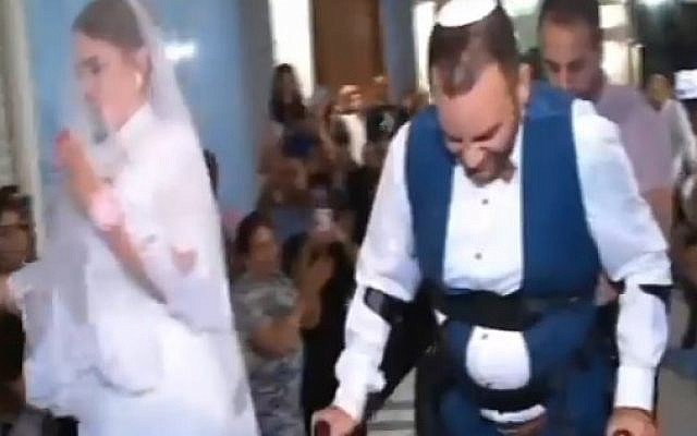 With the help of ReWalk Robotics, Dudu Shevy is able to walk down the aisle (screen capture: Channel 2) With the help of ReWalk Robotics, Dudu Shevy is able to walk down the aisle (screen capture: Channel 2)