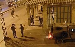 This image posted by Palestinian social media users overnight Saturday purports to show IDF soldiers outside the offices of a Hebron radio station in November, 2015. (screen capture: Facebook)