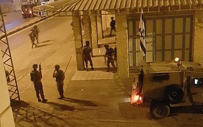This image posted by Palestinian social media users overnight Saturday purports to show IDF soldiers outside the offices of a Hebron radio station in November, 2015. (screen capture: Facebook)