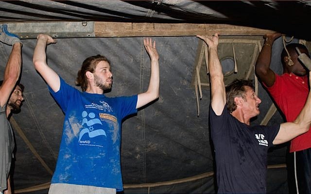 Actor Sean Penn in black t-shirt helping Tevel b'Tzedek volunteers following the earthquake in Haiti, 2010 (photo courtesy Tevel b'Tzedek) Actor Sean Penn in black t-shirt helping Tevel b'Tzedek volunteers following the earthquake in Haiti, 2010 (photo courtesy Tevel b'Tzedek)