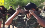 A Fatah fighter bites and chews on a snake in a terror promotion video posted on the organization's Facebook page in November 2015. (Screen capture from YouTube)