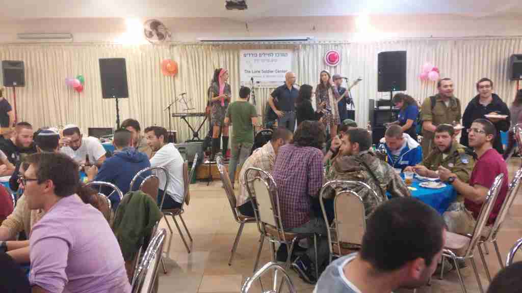 Soldiers in both uniform and civilian clothes enjoy a Thanksgiving meal (Simona Weinglass/The Times of Israel)