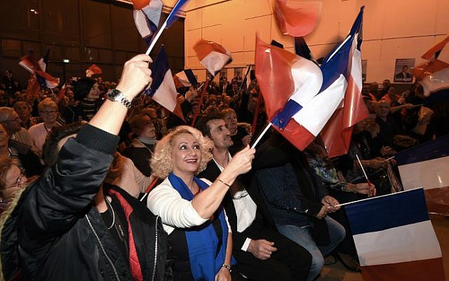 Supporters wave French national flags during a campaign rally of the French far-right Front National (FN) party in Nimes on December 2, 2015 ahead of regional elections. (AFP/Pascal Guyot)