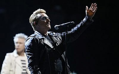 U2 singer Bono speaks to the audience at the Bercy Accordhotels Arena in Paris, December 6, 2015. (Photo by AFP/Thomas Samson)