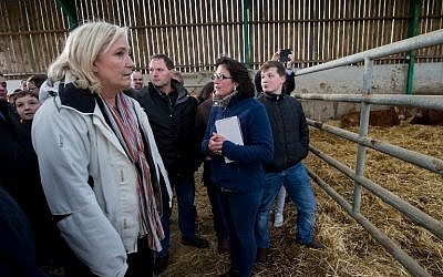 Marine Le Pen, French far-right National Front (FN) president, and candidate in the Nord-Pas-de-Calais Picardie region for the second round of the regional elections, visits a farm as part of her electoral campaign in Quesmy, on December 10, 2015 AFP/DENIS CHARLET)