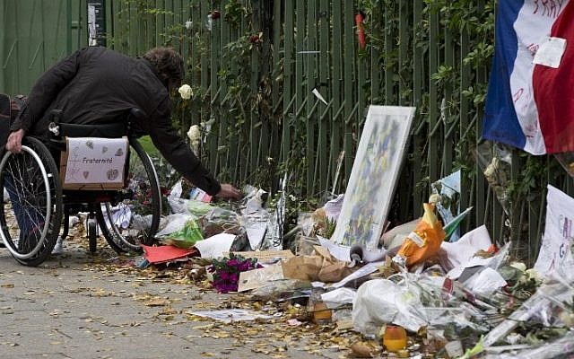 A man in a wheelchair pays tribute to the victims of the November 13 terror attacks at a makeshift memorial near the Bataclan concert hall in Paris on December 10, 2015. (AFP / JOEL SAGET) A man in a wheelchair pays tribute to the victims of the November 13 terror attacks at a makeshift memorial near the Bataclan concert hall in Paris on December 10, 2015. (AFP / JOEL SAGET)