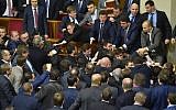 Deputies of Ukrainian Parliament fight after the attack of the Ukrainian Prime Minister during the annual report of the government in Ukrainian Parliament in Kiev on December 11, 2015. (AFP / Sergei SUPINSKY)