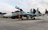Russian servicemen prepare a Russian Sukhoi Su-30SM fighter jet before a departure for a mission at the Russian Hmeimim military base in Latakia province, Syria, on December 16, 2015. (AFP/Paul Gypteau)