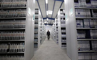 A man walks in a section of the 68 miles of shelving of TV and radio recordings of the French National Audiovisual Institute (INA) at the INA's central archive conservation in Saint Remy L'Honore, December 16, 2015. (AFP/Patrick Kovarik)