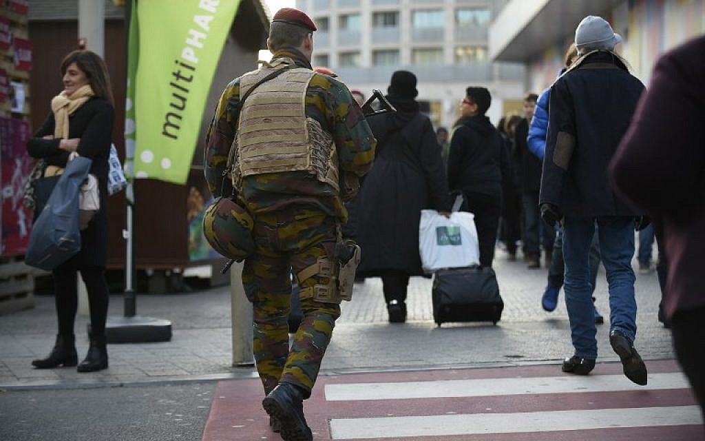 Soldiers patrol in Brussels, on December 31, 2015. 
Battling terror on two fronts, Belgian police were holding eight people Thursday over an alleged New Year plot in Brussels and also arrested a tenth suspect over last month's massacre in Paris. (AFP / JOHN THYS)