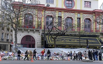 People gather to lay flowers at a makeshift memorial in front of the Bataclan concert hall on November 29, 2015, Paris. (AFP/MIGUEL MEDINA)
