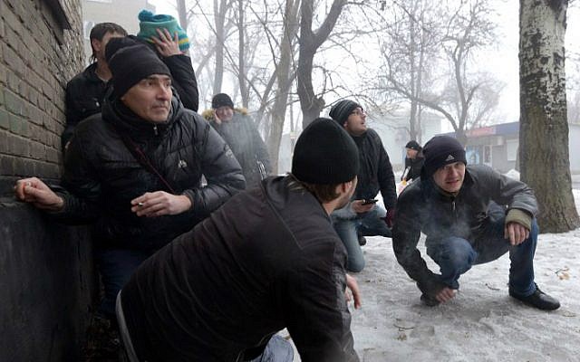 File: People take cover during a shelling in a residential area in Donetsk's Kyibishevsky district, on January 30, 2015. (AFP Photo/Dominique Faget) File: People take cover during a shelling in a residential area in Donetsk's Kyibishevsky district, on January 30, 2015. (AFP Photo/Dominique Faget)