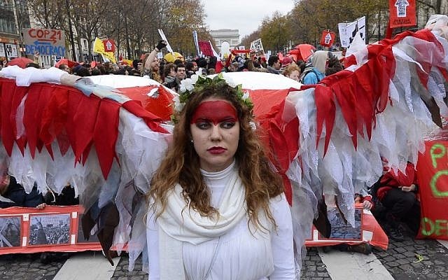 An activist joins others to form a giant red line during a demonstration near the Arc de Triomphe in Paris on December 12, 2015, as a proposed 195-nation accord on climate change is presented at a UN conference in Le Bourget. (AFP PHOTO/ALAIN JOCARD) An activist joins others to form a giant red line during a demonstration near the Arc de Triomphe in Paris on December 12, 2015, as a proposed 195-nation accord on climate change is presented at a UN conference in Le Bourget. (AFP PHOTO/ALAIN JOCARD)