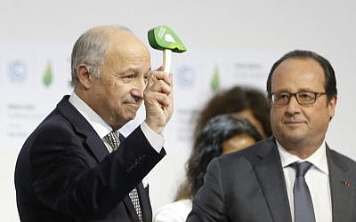 File: French Foreign Affairs Minister and President-designate of COP21 Laurent Fabius (L) waves the official gavel of the UN climate conference, as President Francois Hollande looks on, after adoption of a historic global warming pact in Bourget, north of Paris, on December 12, 2015. (AFP PHOTO/FRANCOIS GUILLOT)
