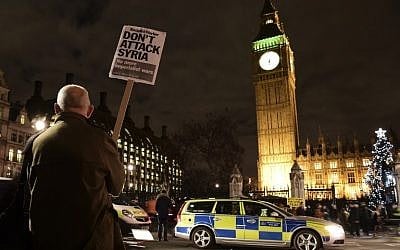 A protester holds a placard reading 'Don't attack Syria' during a demonstration against British military action in Syria outside the Houses of Parliament in London, December 1, 2015. (Photo by AFP Photo / Leon Neal) A protester holds a placard reading 'Don't attack Syria' during a demonstration against British military action in Syria outside the Houses of Parliament in London, December 1, 2015. (Photo by AFP Photo / Leon Neal)