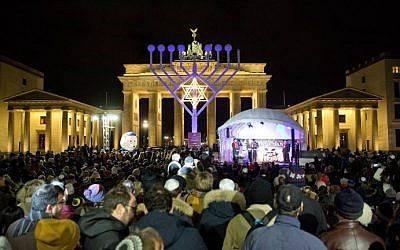 People stand in front of a giant eight-branched Hanukkah candelabrum in front of the Brandenburg Gate in Berlin on December 6, 2015 at the start of the eight-day Jewish holiday. (AFP Photo/DPA/Jorg Carstensen) People stand in front of a giant eight-branched Hanukkah candelabrum in front of the Brandenburg Gate in Berlin on December 6, 2015 at the start of the eight-day Jewish holiday. (AFP Photo/DPA/Jorg Carstensen)